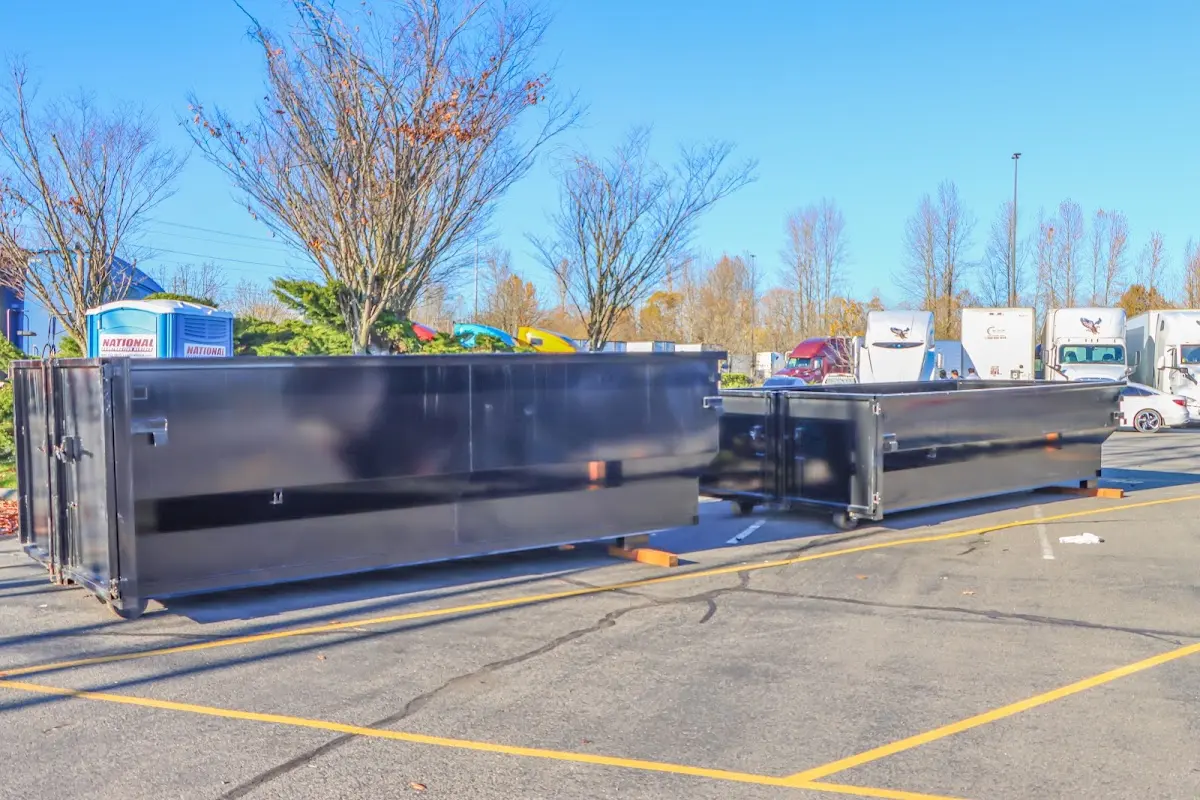 Professional dumpster rental service with roll-off container on residential driveway in Rockville